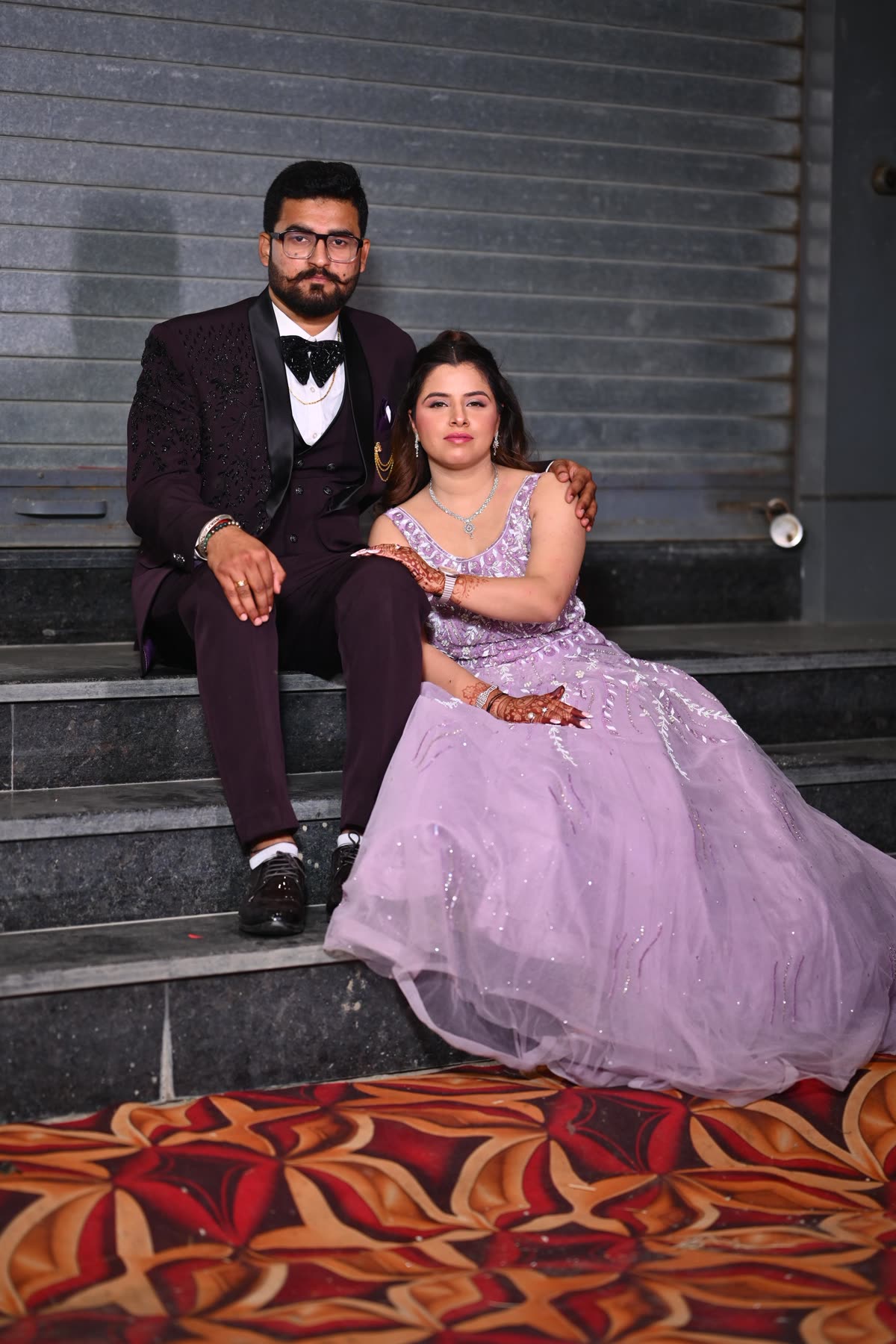 Anukriti and Anmol seated together in formal celebration attire