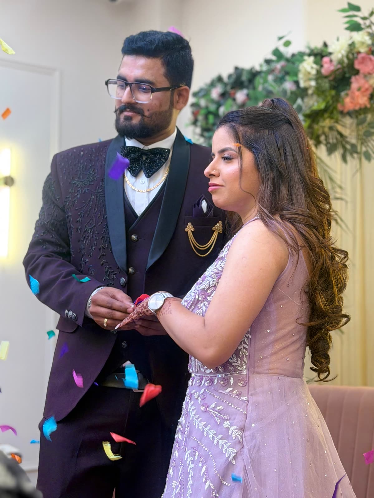 Anukriti and Anmol dancing as confetti falls around them